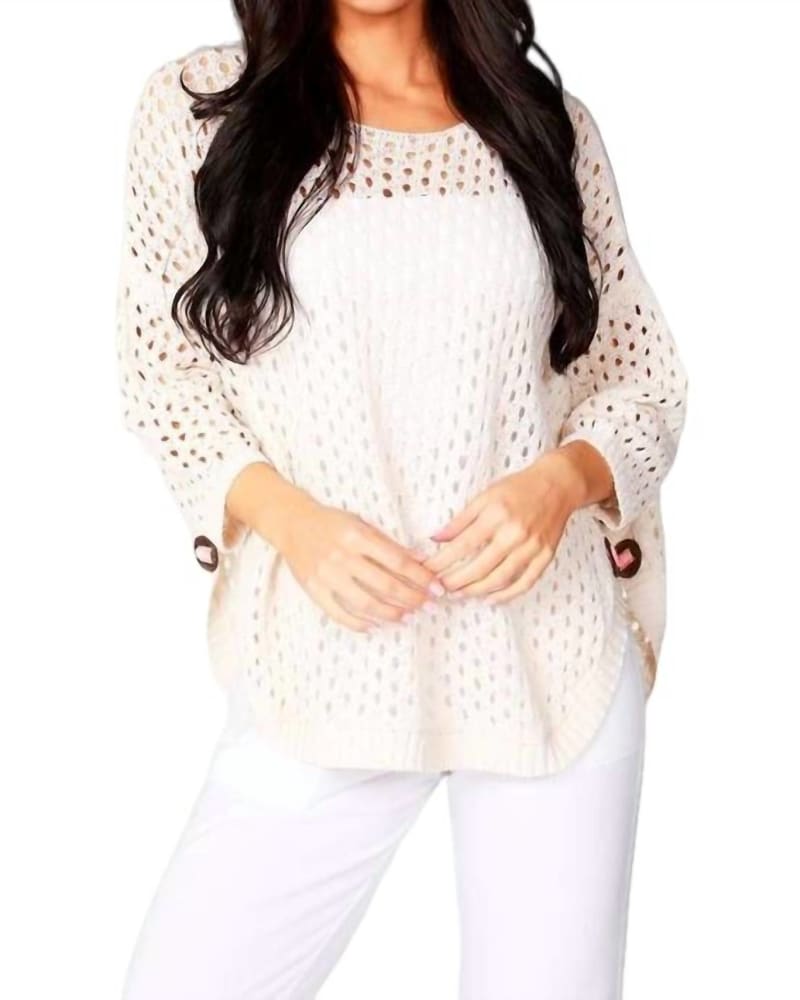 Front of a model wearing a size XL Aimee Wooden Button Poncho in Beige in Beige by french kyss. | dia_product_style_image_id:325682